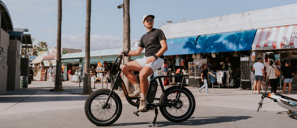 a man sitting on a Rad Power RadRunner 2 electric bike in Los Angeles