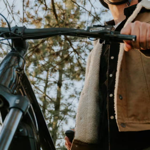 a man standing next to an electric mountain bike
