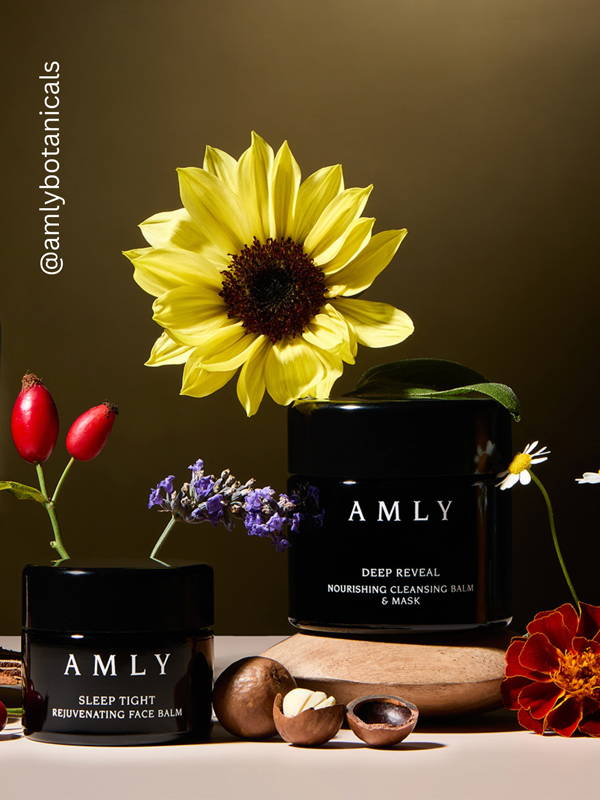 AMLY botanicals Deep Reveal and Sleep Tight surrounded by flowers, berries and nuts