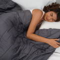 woman feeling clam while sleeping under weighted blanket