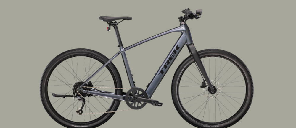 a silver Trek Dual Sport+ 2 electric city bike