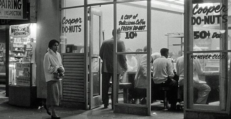 Black and white image of people sitting at the shop.