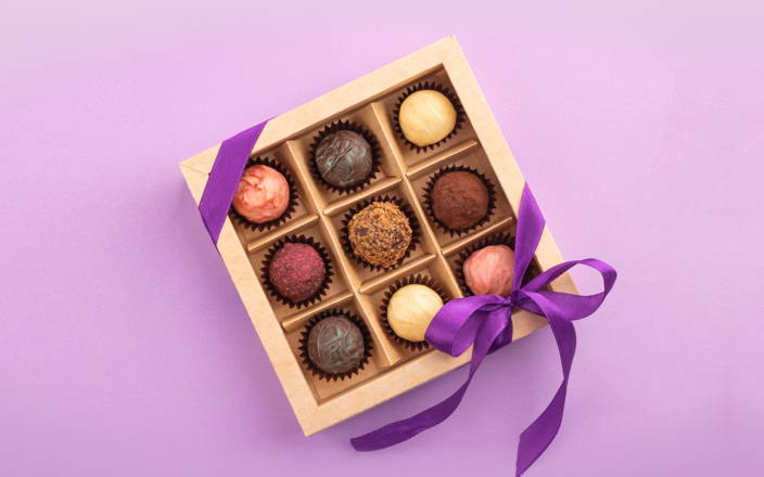 Chocolate gift box wrapped with a purple ribbon (preview)