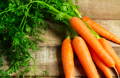 freshly picked and washed carrots on a wooden table 