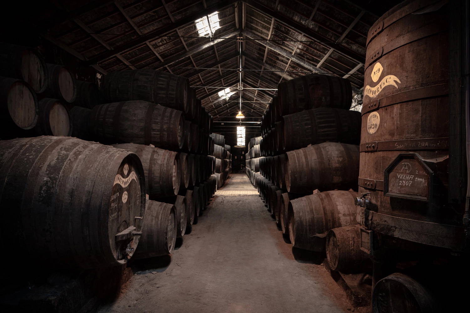 Two stacks of wine casks and a Deep Yellow Coolicon lamp in the back