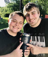 father and son holding custom logo tumbler engraved with logo past happy kodiak wholesale promotional products customer