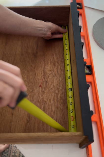 Measuring interior of drawer with measuring tape