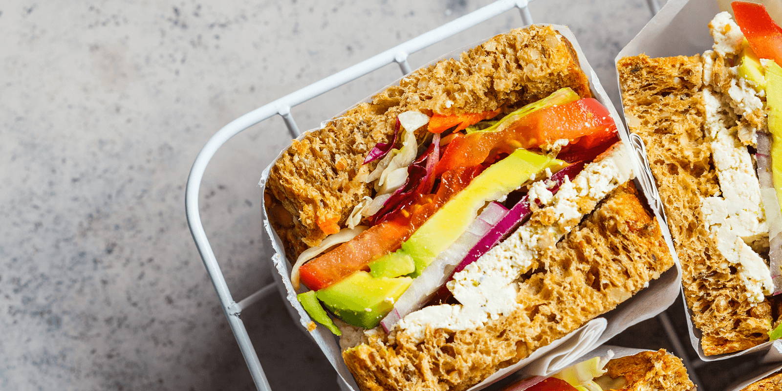 Sandwich cut in half on a platter.