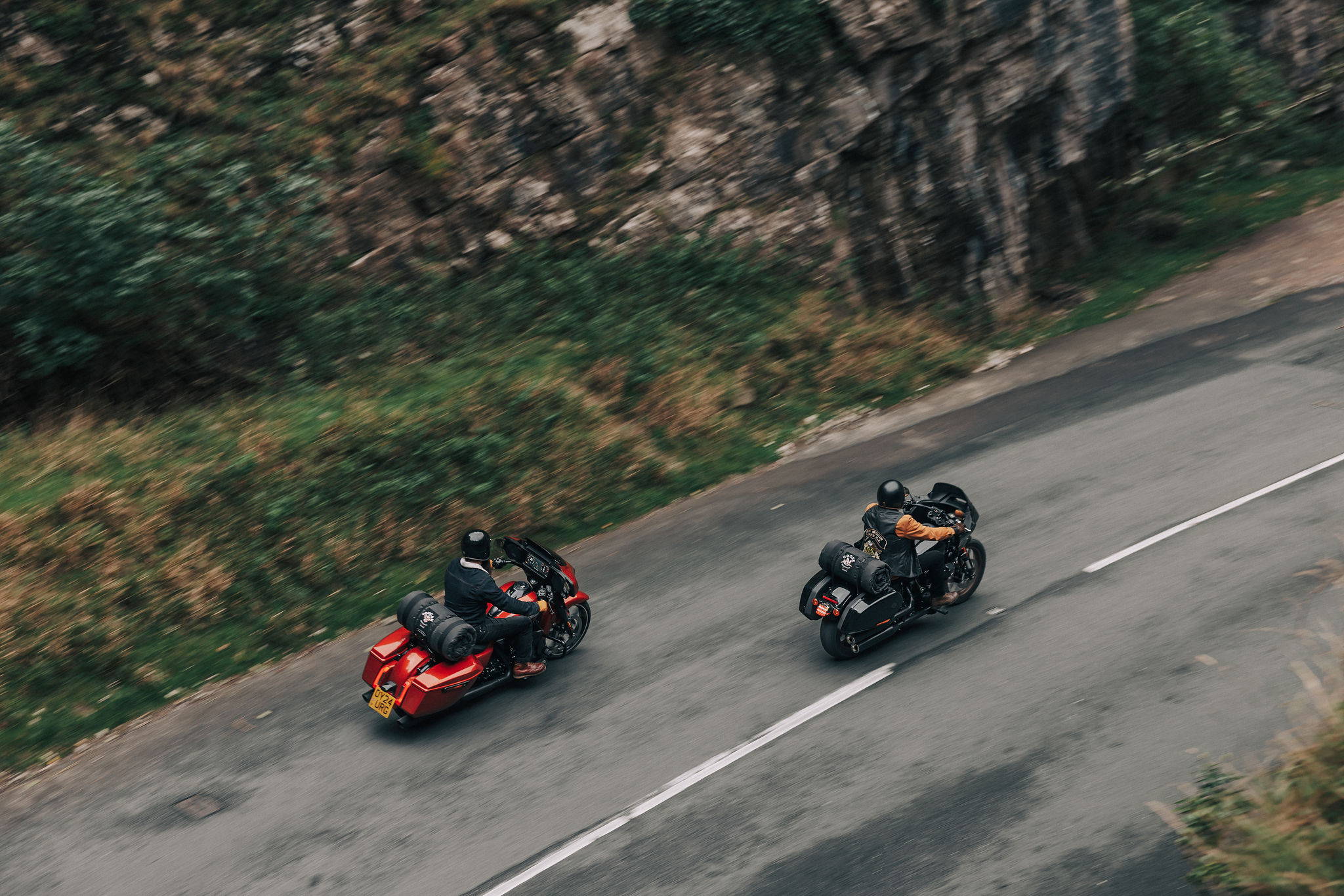 Two Wingman of the Road customers riding motorcycles with camping systems attached
