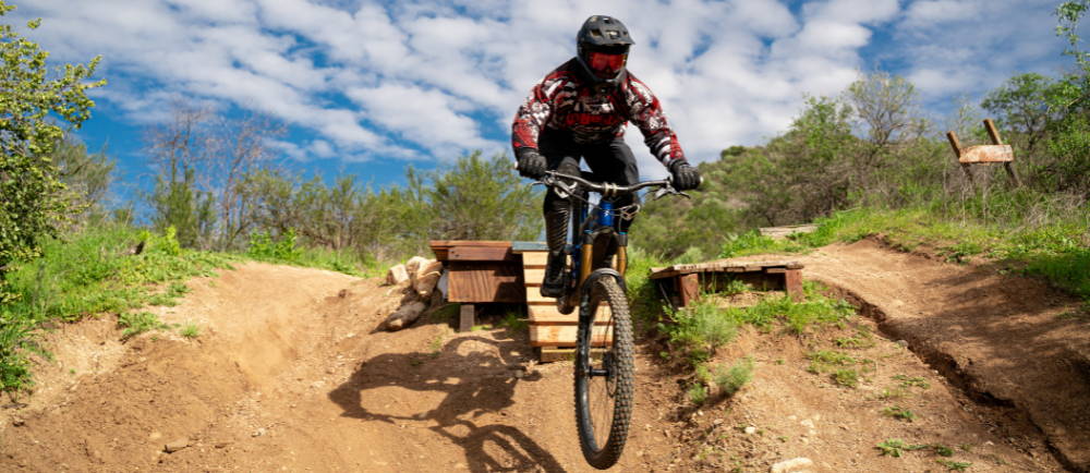 Electric mountain bike rider off jump