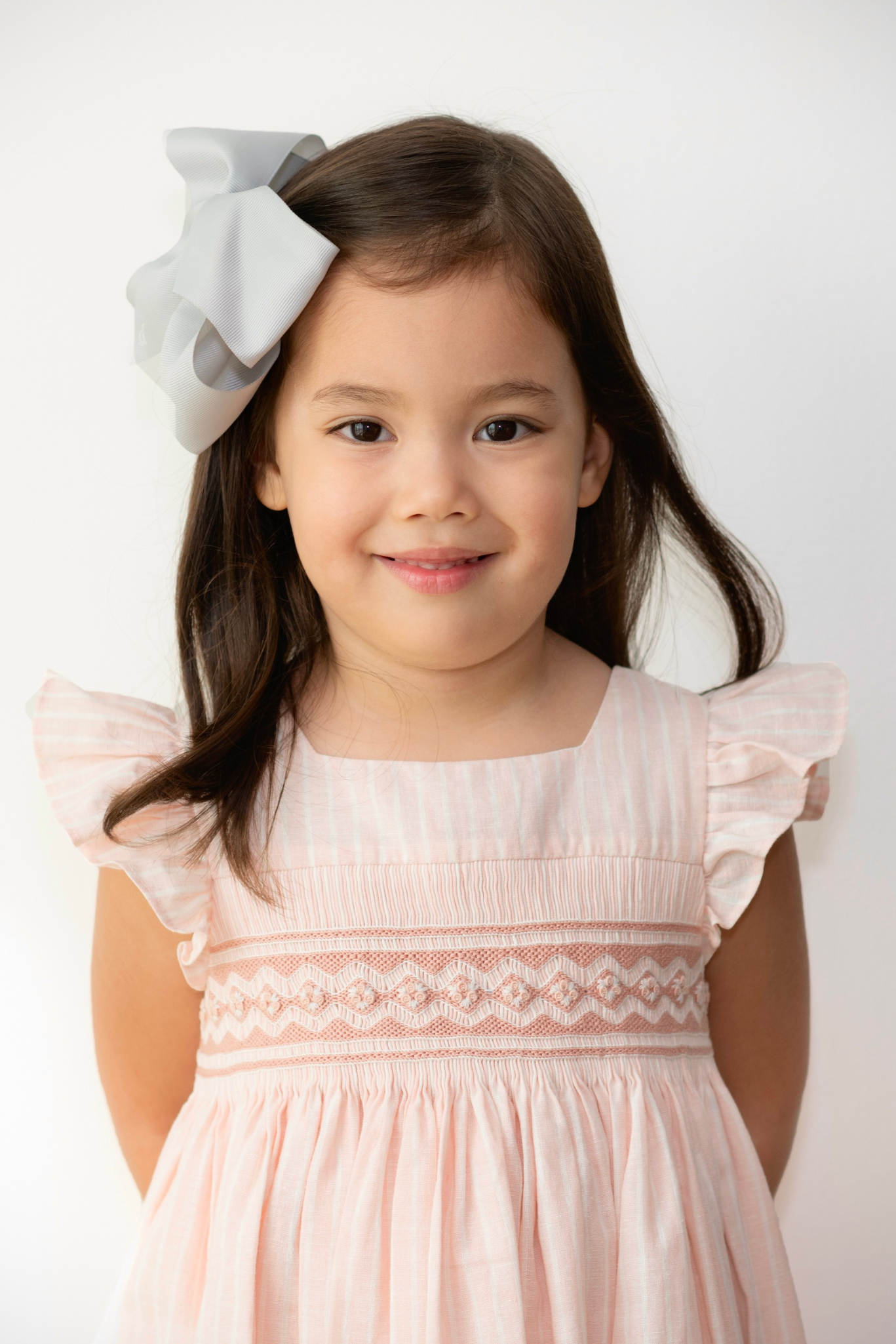 Traditional salmon pink smocked dress