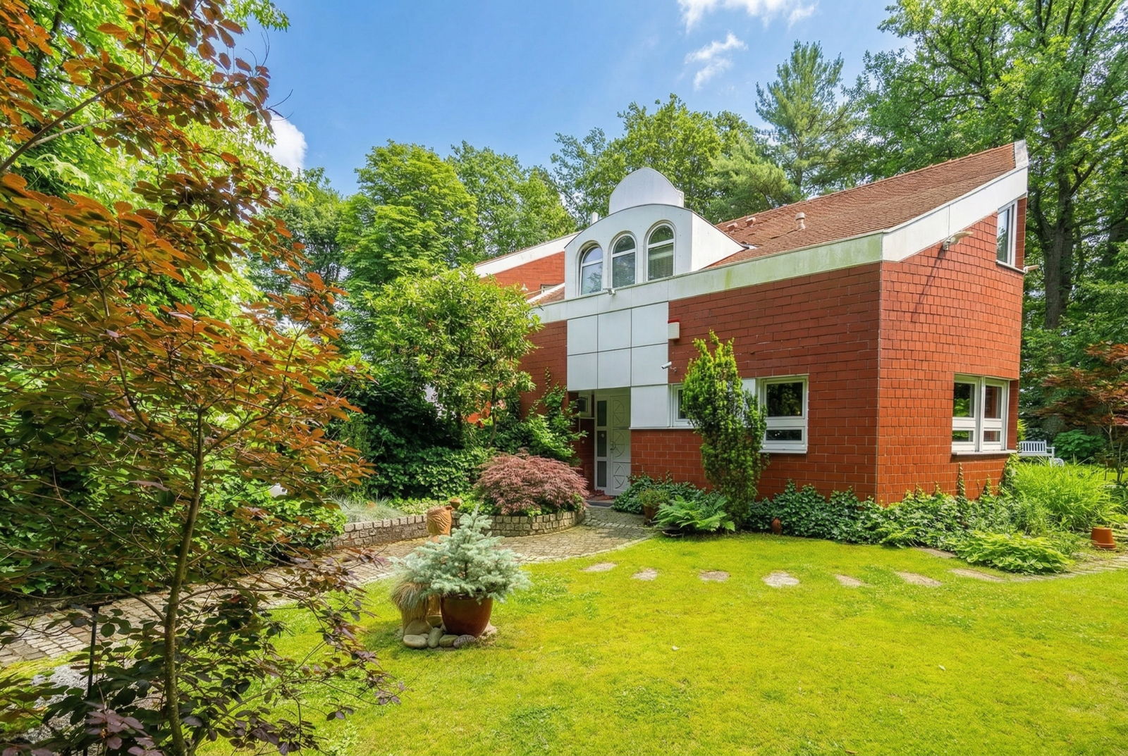 Exclusive architecture with expansive gardens and pond landscape