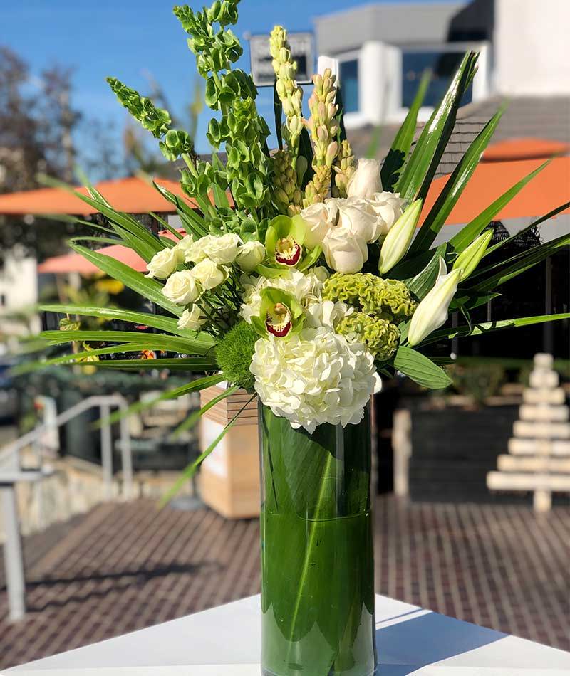 White and green bouquet of flowers placed outside