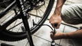 man inflates a bicycle tire