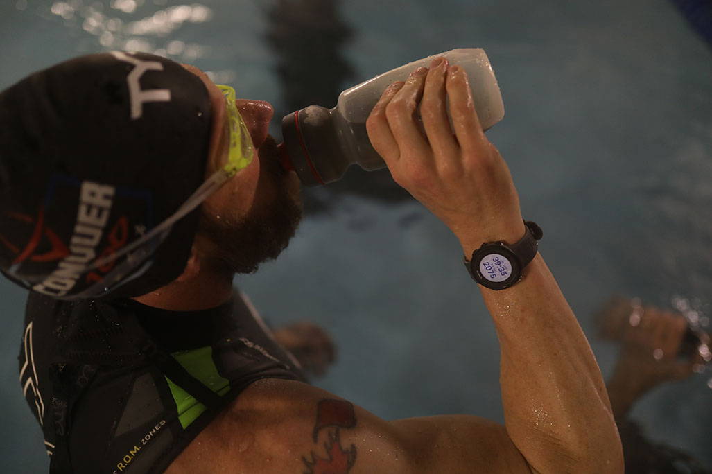 James Lawrence drinking from bottle while in pool