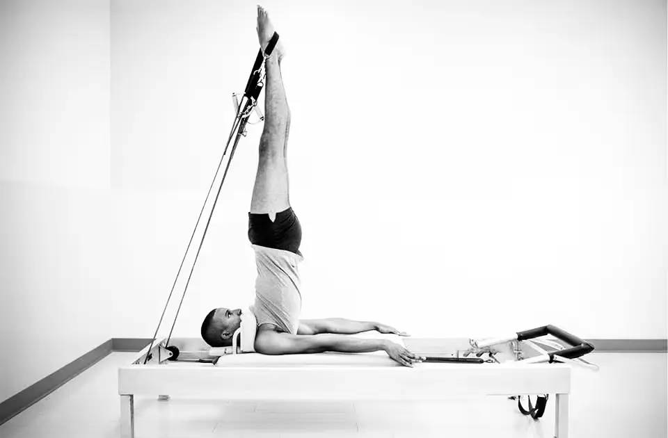 Brett Howard exercising on reformer