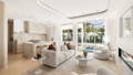 Havit white LED downlights brighten an open-plan space, highlighting a stone island, herringbone floors and curved plaster ceiling.