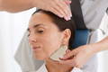 woman massagging her face with a gua sha