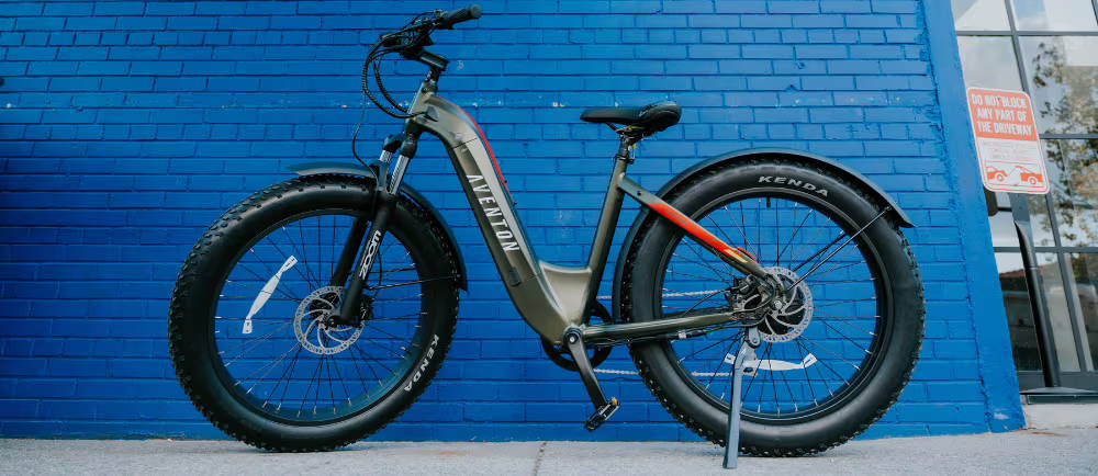 Aventon Aventure electric bike in front of blue wall
