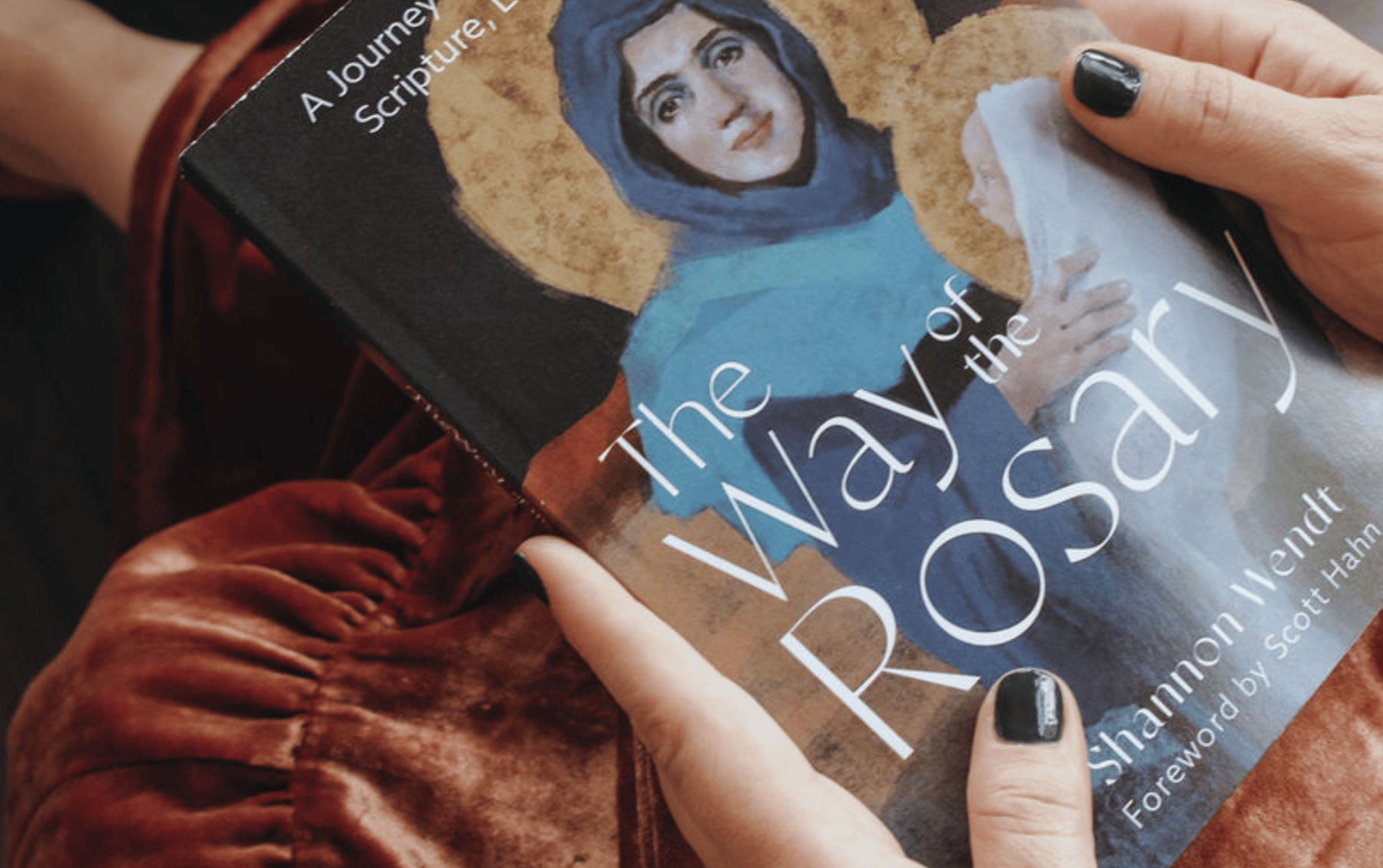 Hands holding The Way of the Rosary