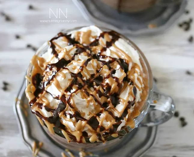Hot chocolate with whipped cream and peanut butter drizzle