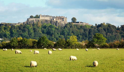 Looking up at the formidable Stirling Castle siting on top of a tree covered volcanic plug with views in all directions