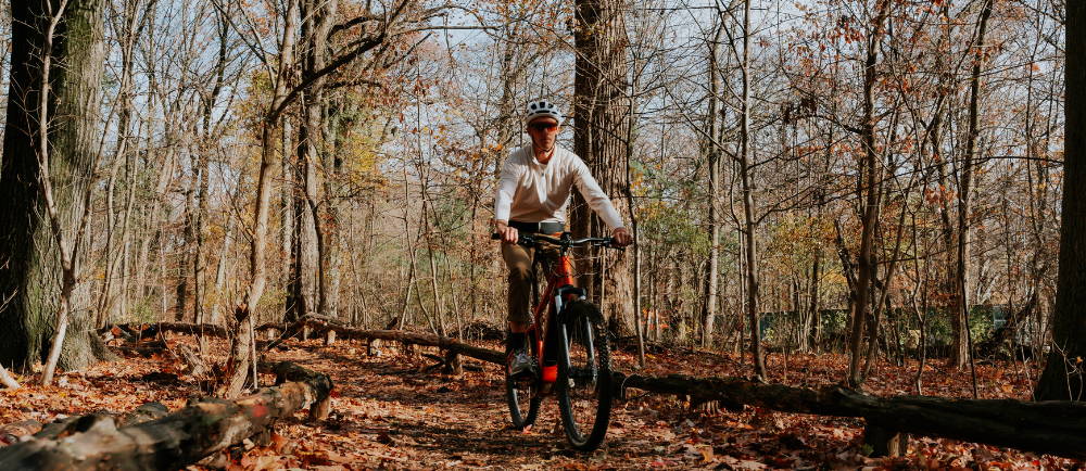 An E-MTB being ridden in a forest.