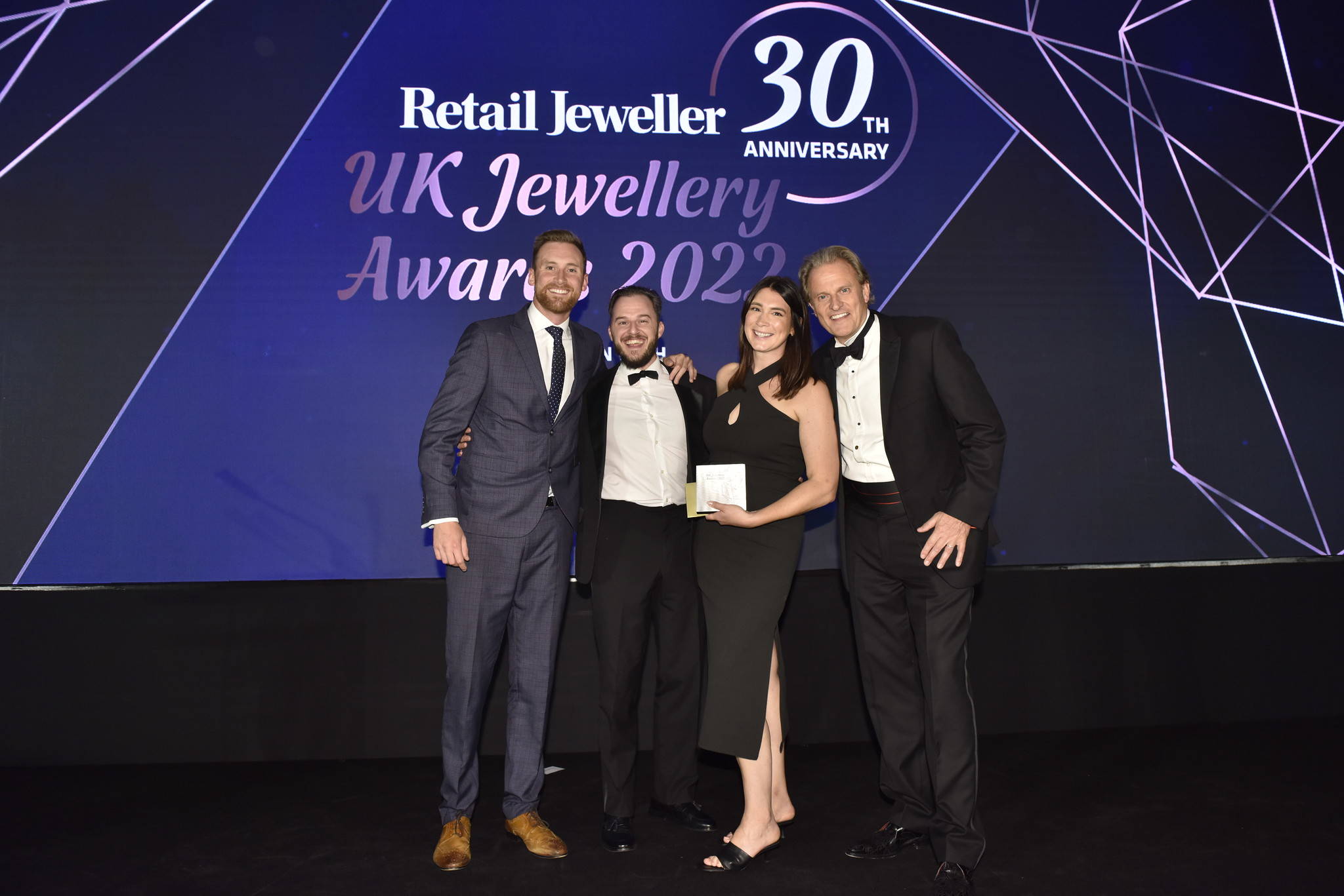 The Flinn & Steel team are presented with a trophy on stage at the UK Jewellery Awards in London's Hilton Metropole.