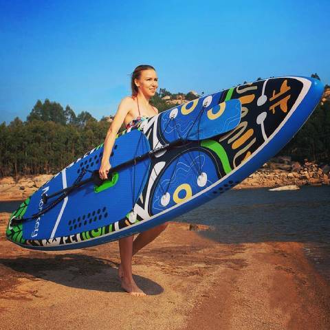 Girl lift lightweight inflatable paddle board in British Columbia