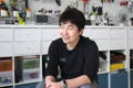 Matcha Maker engineer, Naoto, smiles during a Cuzen interview, his tools Behind him.