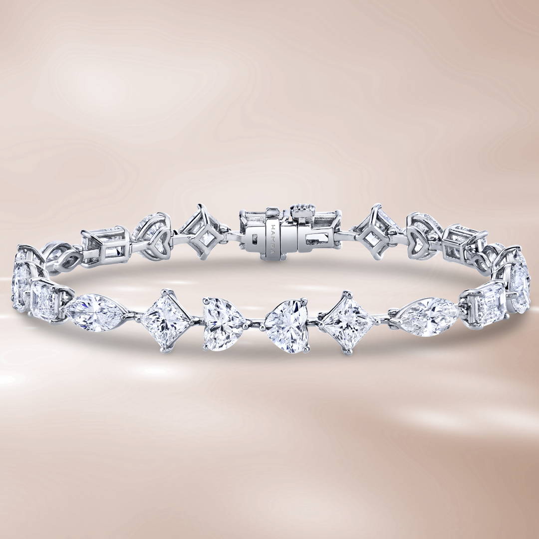 Multi shaped stone diamond bracelet in platinum on a brown background