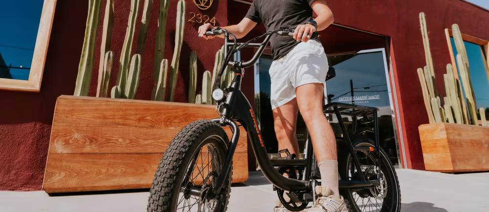Rider with RadRunner 2 ebike on sidewalk