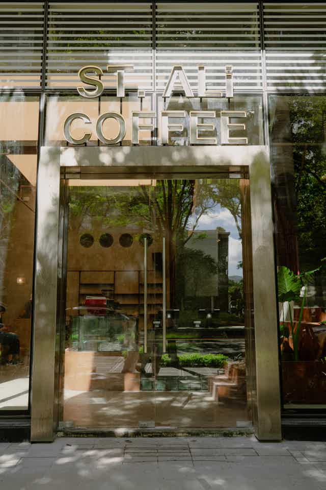 Barista serving two people their coffees 