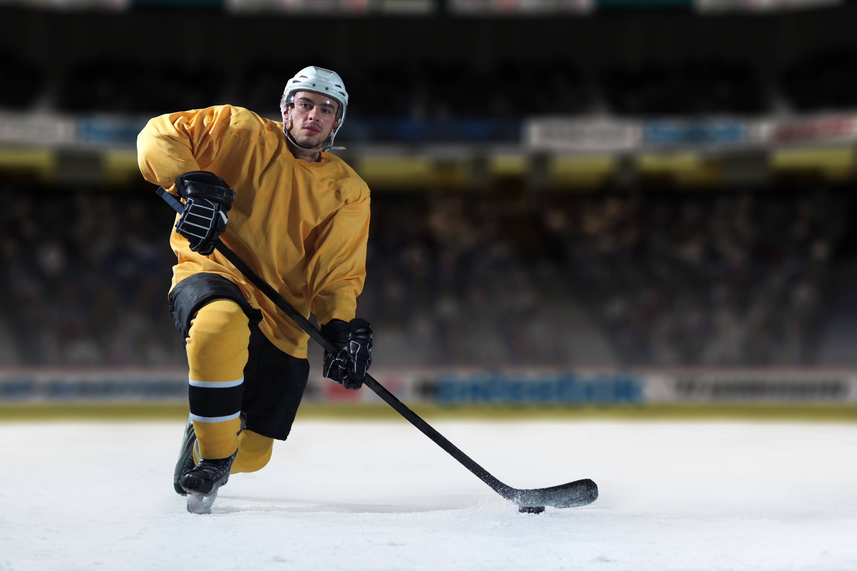 Yellow hockey player is prepearing to game