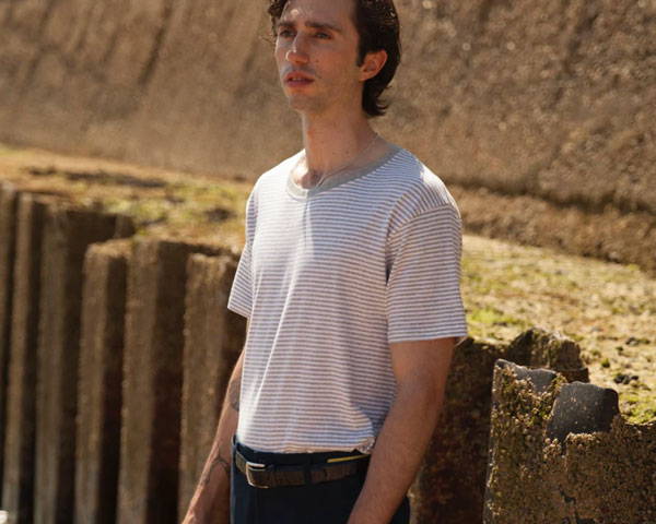 Man wearing grey striped organic cotton t-shirt from sustainable menswear brand Goose Studios, based in the United Kingdom