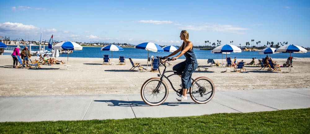 Woman riding Tower electric bike near beach