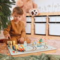 A festive setup created with the Montessori Christmas Railway, featuring a wooden board with a track, and figurines that travel around it.