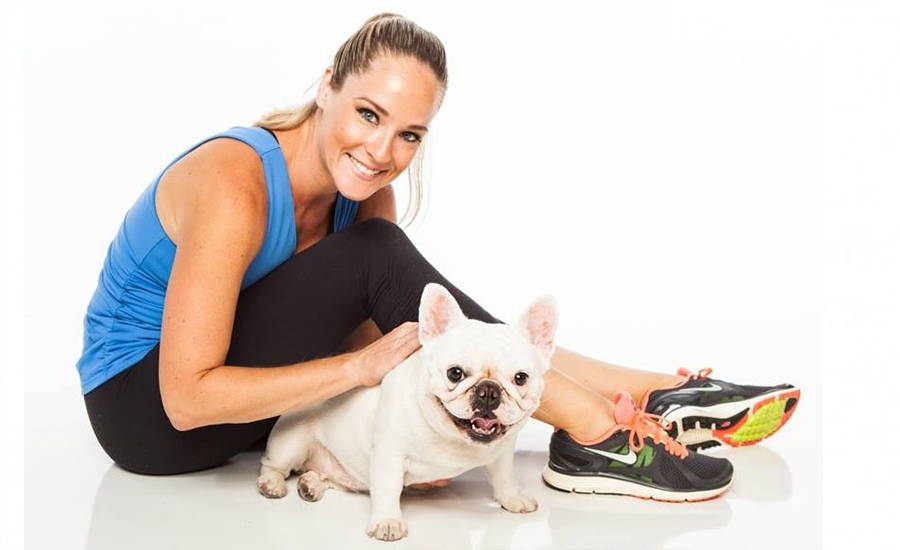 A woman in athletic clothing with her dog