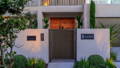 Havit outdoor lighting illuminating modern home entry and front landscaping at dusk