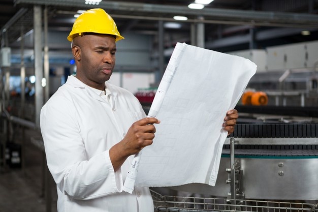 Male worker reading instructions juice factory 107420 96065