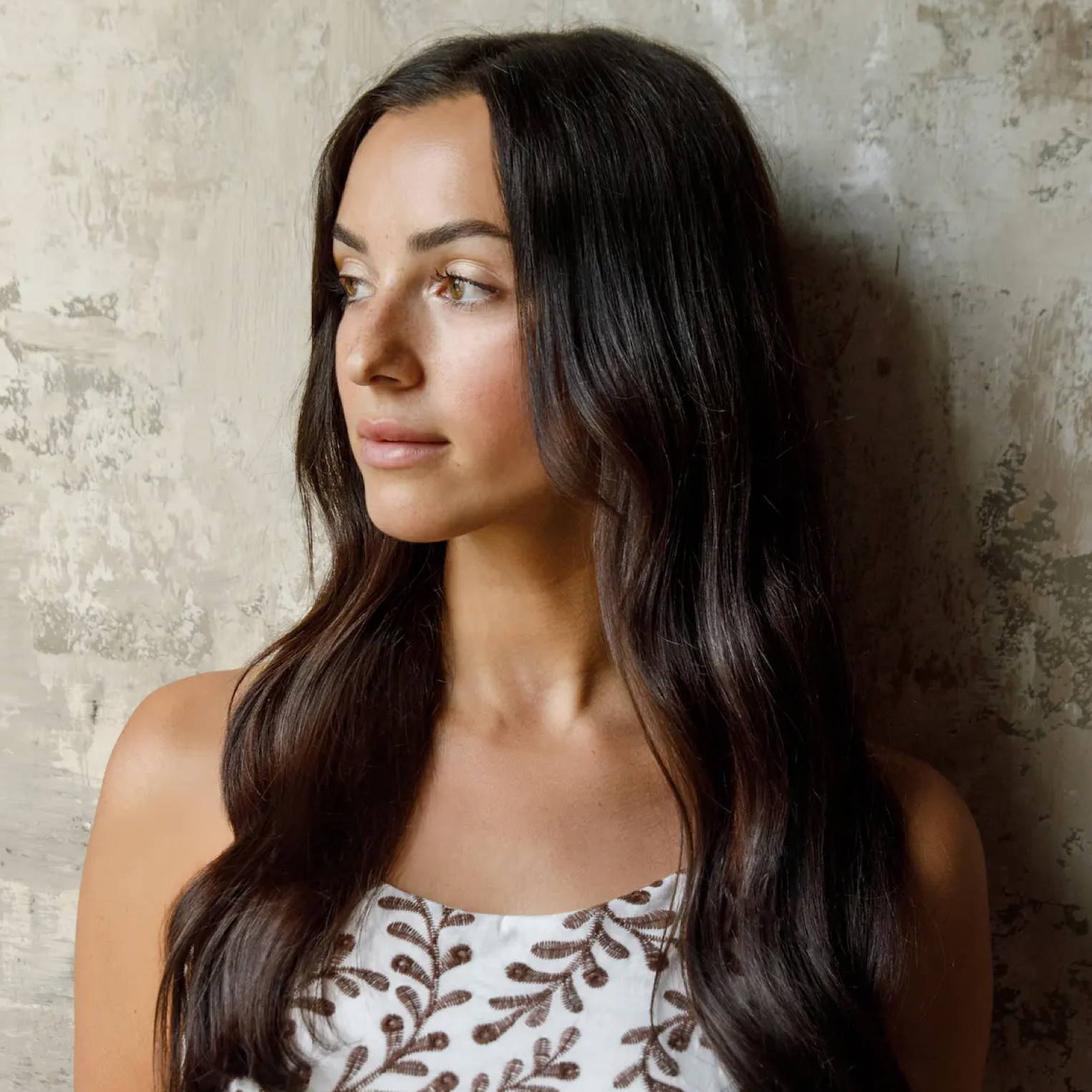 Davines hair model with long, dark brown hair