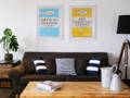 beach house art framed art prints hanging above a sofa in a house in cornwall