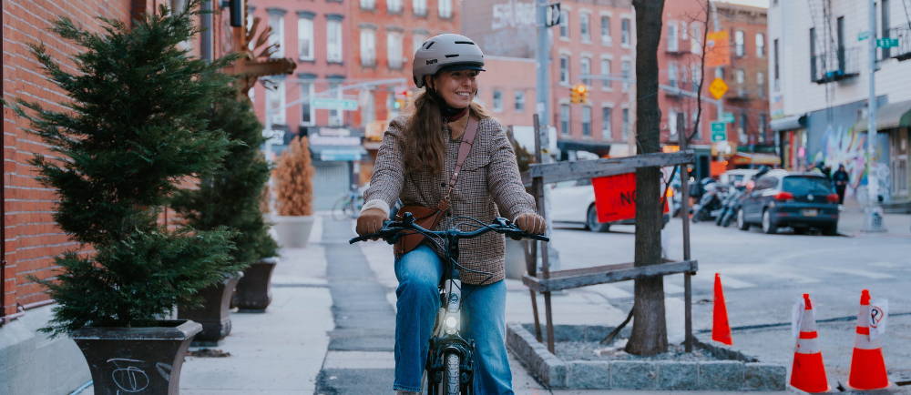 female riding an e-bike in a city