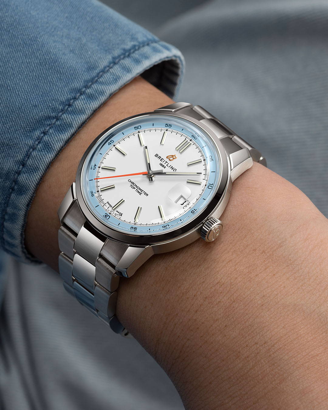 New Breitling Top Time B31 watch in light blue and white with a stainless steel bracelet