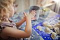 Young child making homemade dough shapes during a hands-on sensory activity at home.