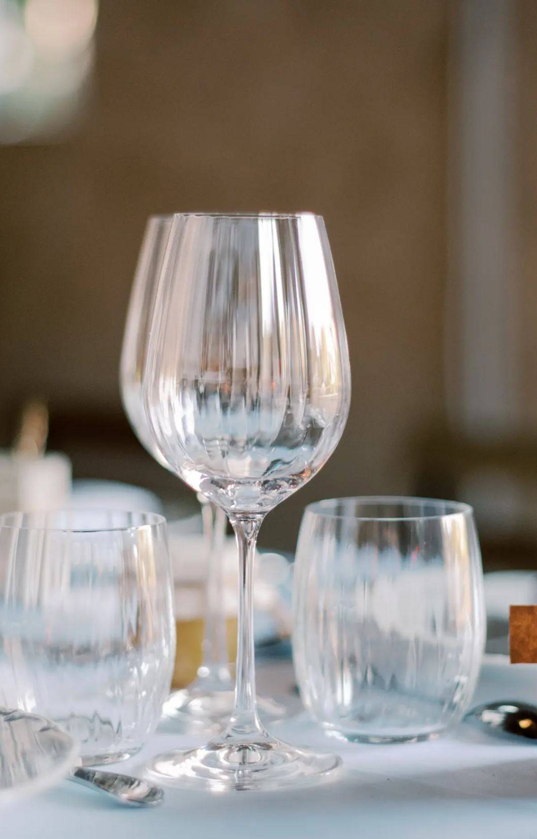 Verres à vins vides disposés sur une table de mariage, prêts à être remplis de délicieux vins sélectionnés pour l'occasion.
