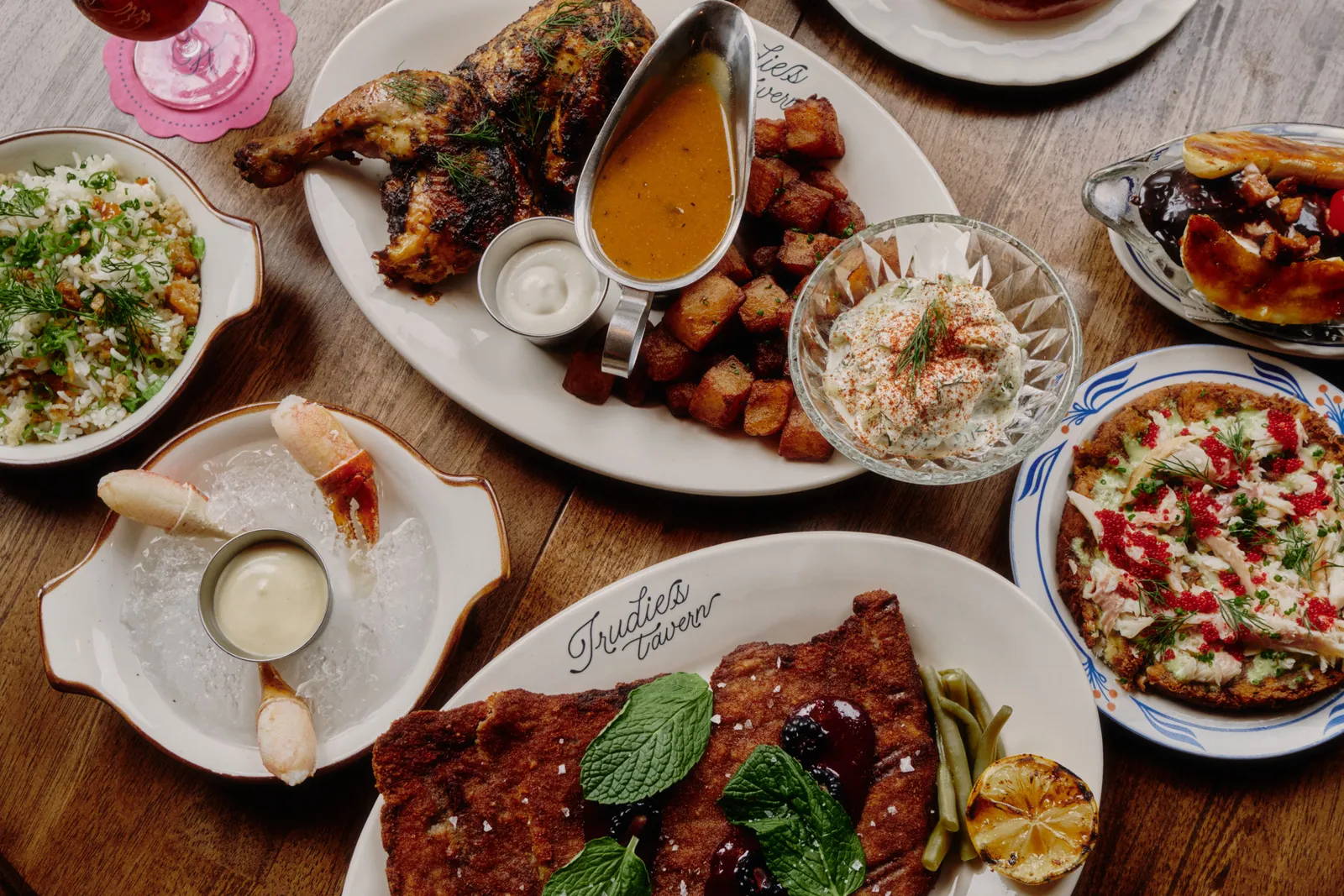 Dishes of food on a wood table.