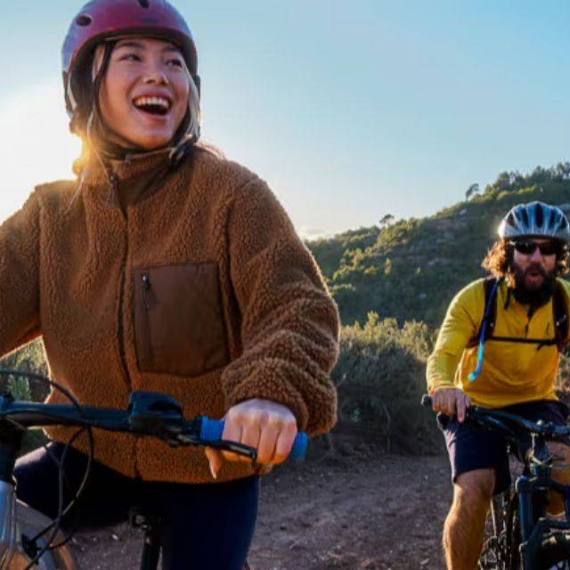 2 happy people mountain biking
