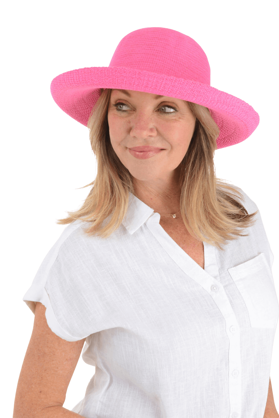 A woman wears a pink straw hat and a white blouse against a yellow background
