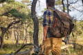 Man wearing an Isle Royale pack standing in the woods.